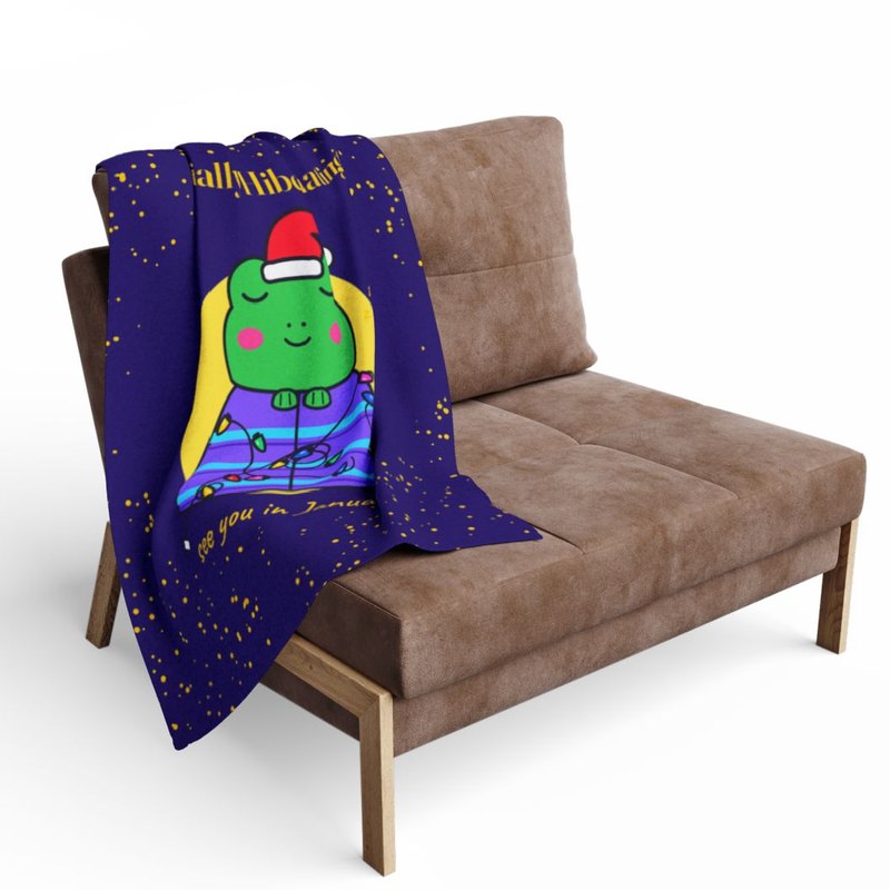Fleece throw printed edge to edge with the Socially Hibernating Christmas frog in bright, draped over a chair